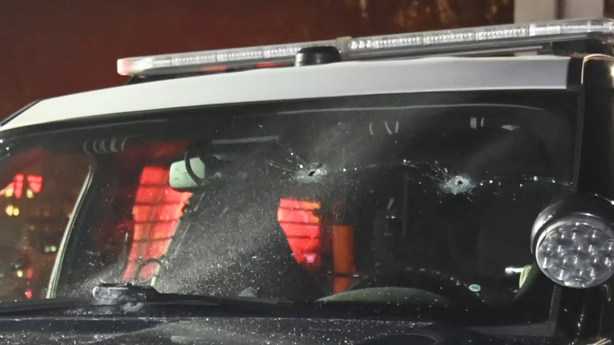 bullet holes are seen in windshield of San Jose PD patrol car