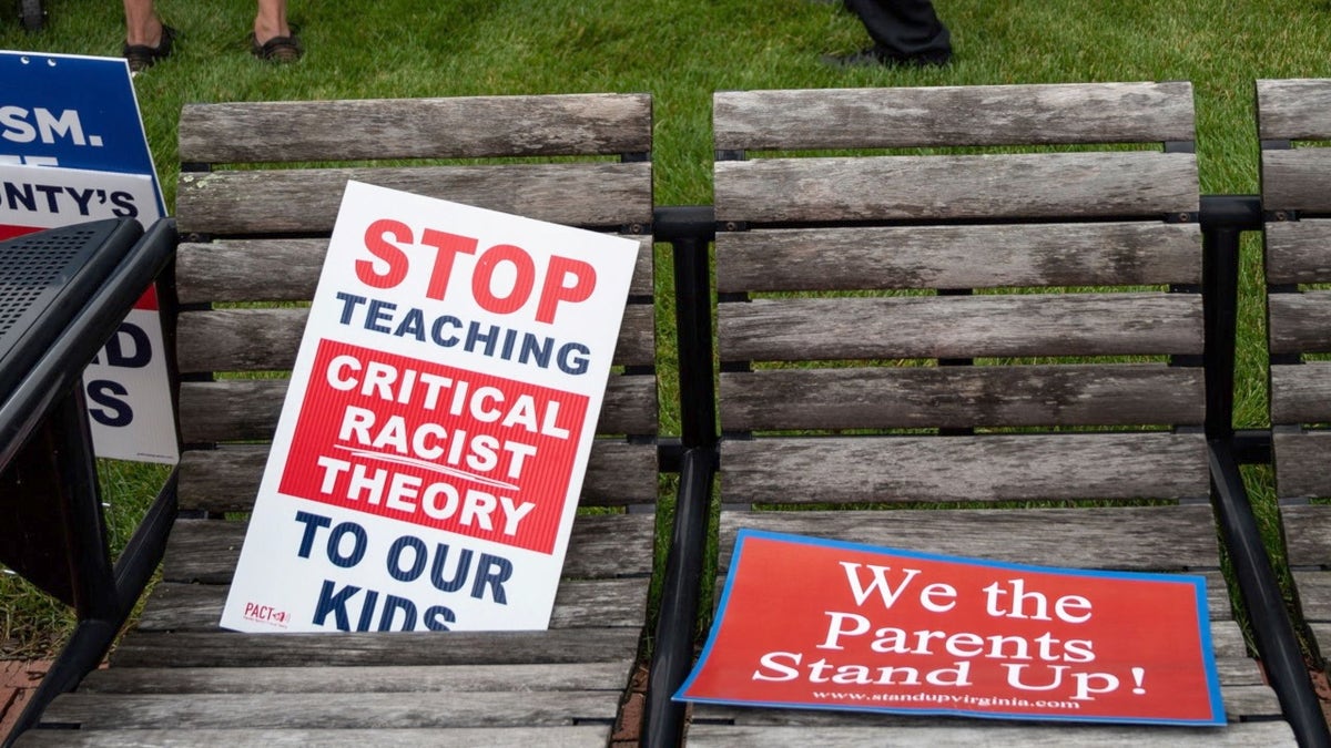 Signs from parents against critical race theory in schools