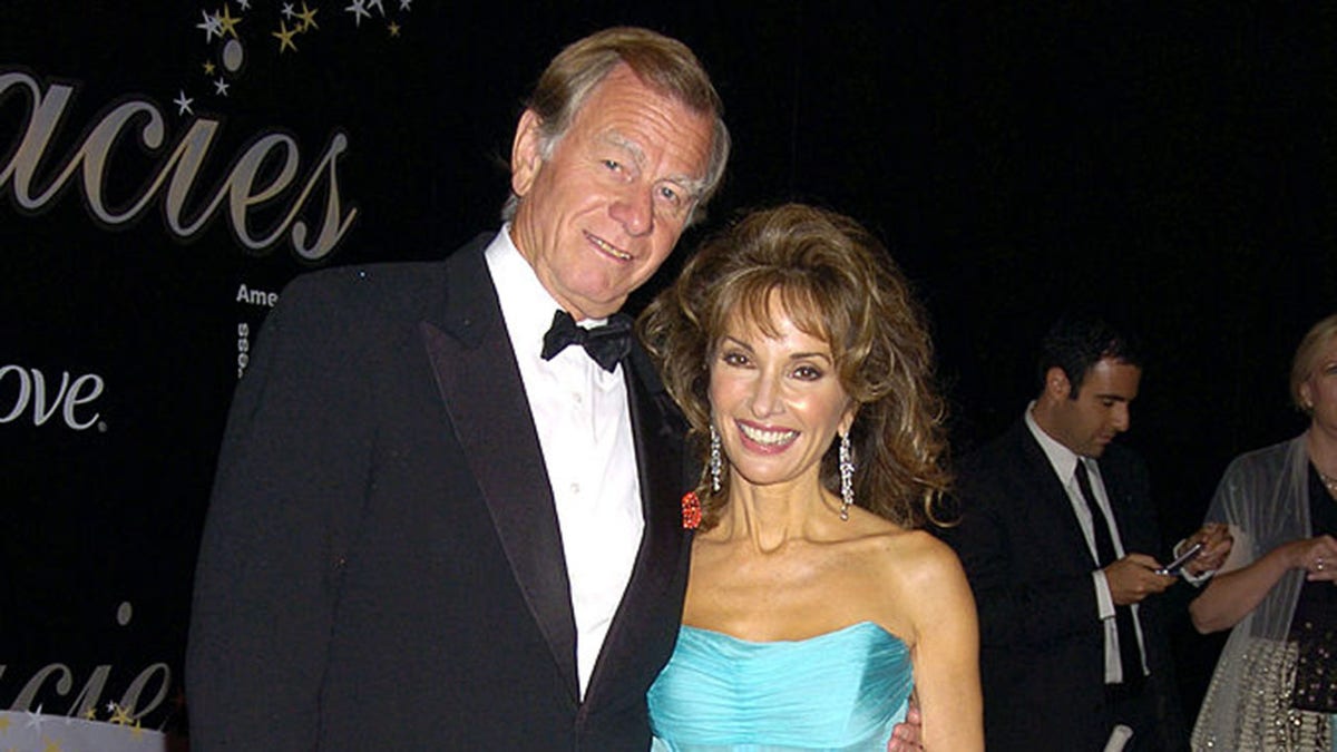 Susan Lucci and Helmut Huber smiling together at an event