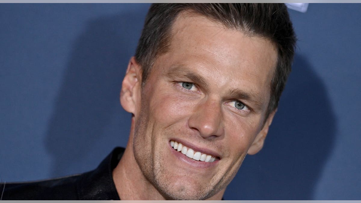 Tom Brady smiles on red carpet