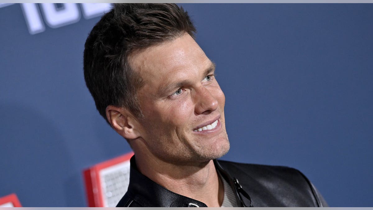 Tom Brady smiles on red carpet