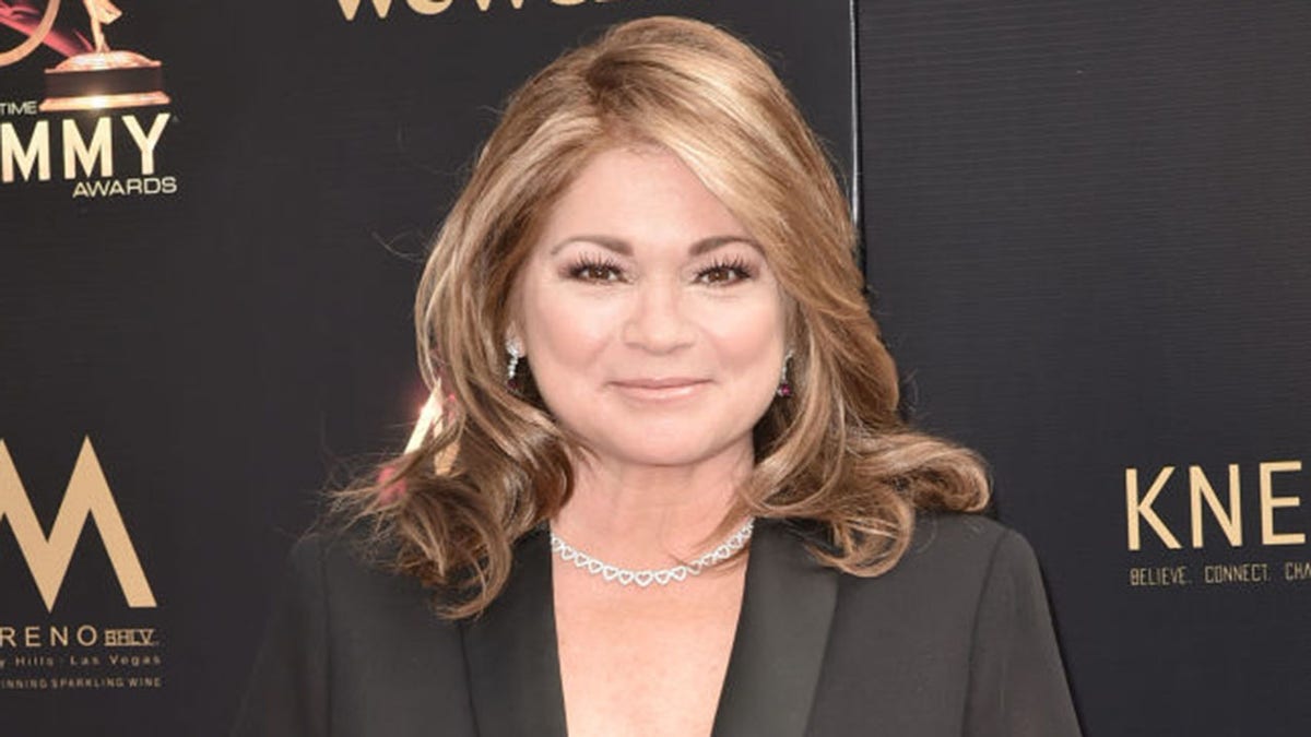 Valerie Bertinelli smiles at a red carpet event.