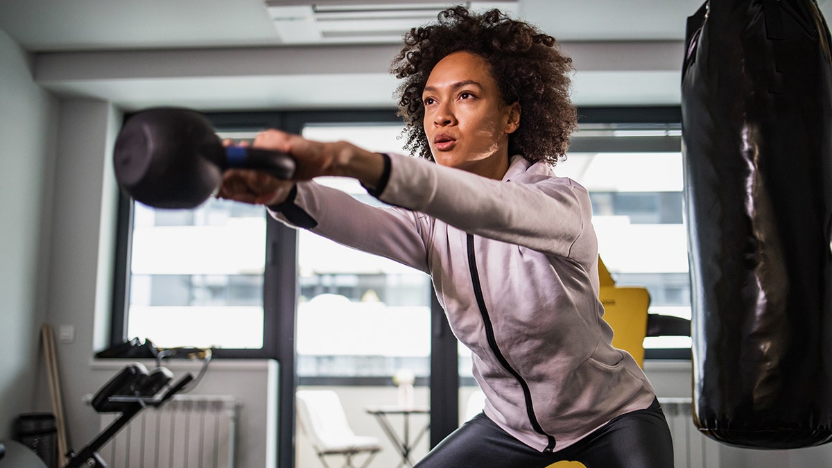 Woman lifting weights at the gym