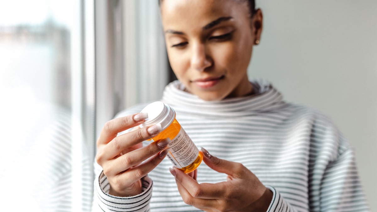 woman holding medicine