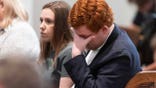 Buster Murdaugh holds his head in his hands while listening to Alex Murdaugh's testimony.