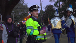 Female NOPD officer stands watch along the parade route