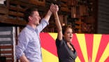 QUEEN CREEK, AZ - NOVEMBER 06: Arizona Republican gubernatorial candidate Kari Lake (R) and Arizona U.S. Senate candidate Blake Masters raise their arms at a campaign rally on November 05, 2022 in Queen Creek, Arizona. Lake faces Democratic Arizona Secretary of State Katie Hobbs in Tuesday's general election, which polls suggest is virtually tied.