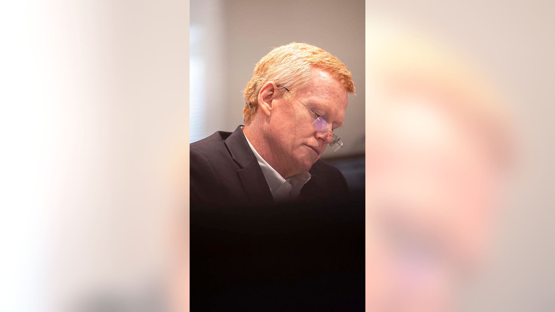 A man wearing glasses listens while in court.