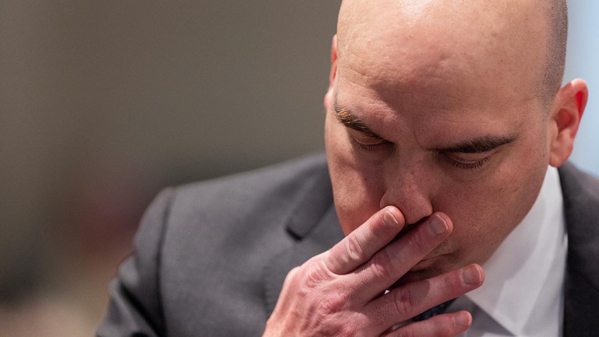 Prosecutor John Conrad listens to testimony from FBI Agent Dwight Falkofske.