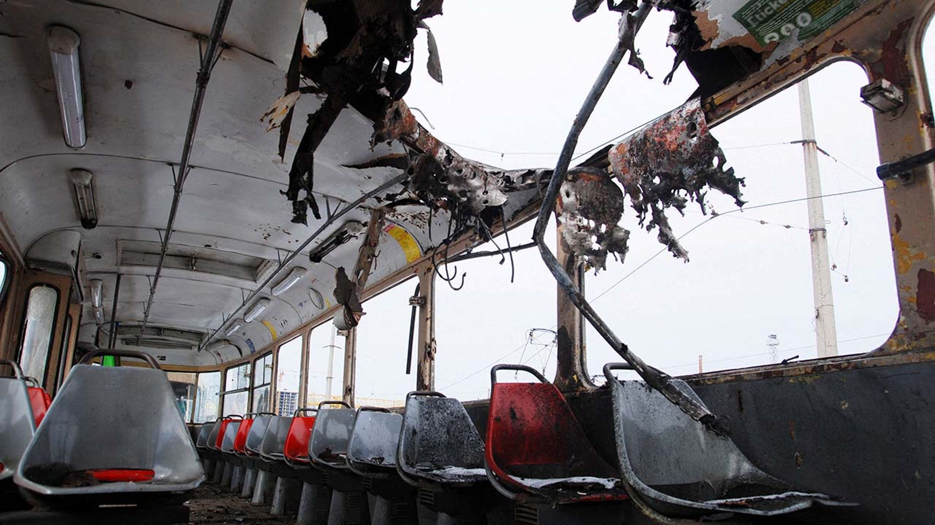 The roof of a bus is blown up.
