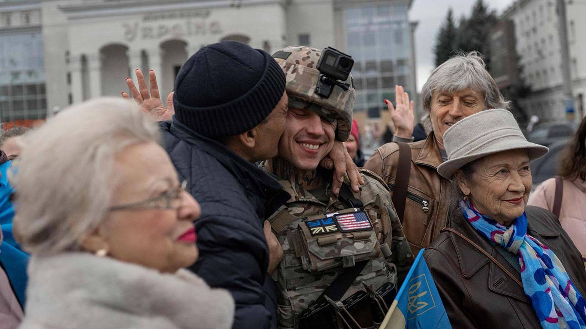 A man hugs a Ukrainian soldier as local residents gather to celebrate the liberation of Kherson, on November 13, 2022, amid Russia's invasion of Ukraine. - Ukrainians in the liberated southern city of Kherson expressed a sense of relief on November 11, 2022, after months of Russian occupation. There were no scenes of jubilation on November 13, 2022, an AFP correspondent said, but many locals said they felt a great sense of relief after Kyiv had wrested back control of the city.