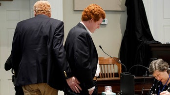 Alex Murdaugh pats son Buster's backside after he testified