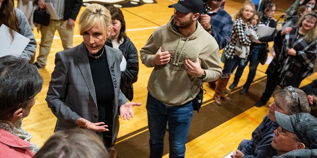 Environmental activist Erin Brockovich (R) speaks to concerned residents as she hosts a town hall at East Palestine High School on February 24, 2023 in East Palestine, Ohio.