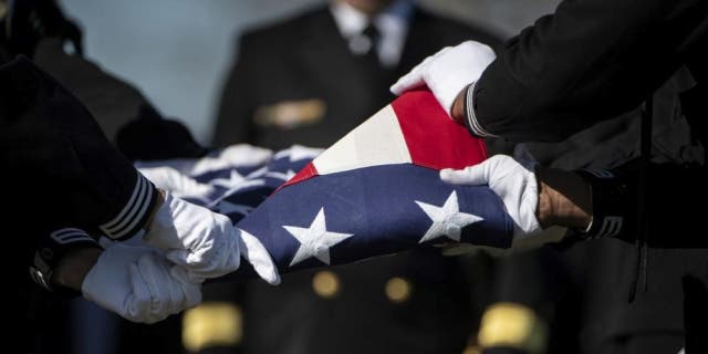 Sailors from the U.S. Navy Ceremonial Guard and the U.S. Navy Ceremonial Band conduct military funeral honors for U.S. Navy Gunner’s Mate 3rd Class Herman Schmidt in Section 70 of Arlington National Cemetery in Arlington, Va., Feb. 23, 2023.