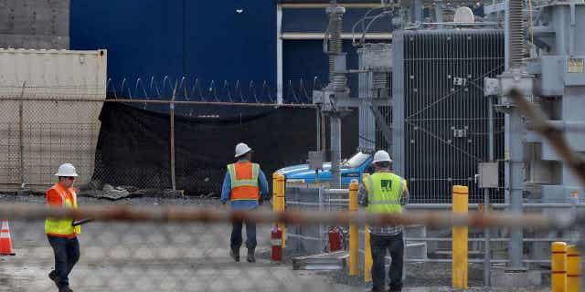 PG&amp;E workers at the site of a substation where a fire earlier in the day caused a power outage throughout parts of Oakland, Calif., on Sunday, Feb. 19, 2023. 