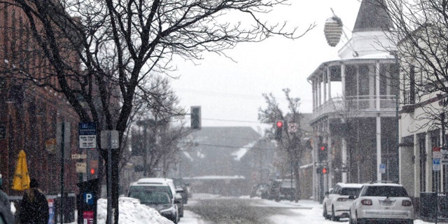 The acorn on the Weatherford in downtown Flagstaff, Ariz., hangs amidst a heavy fall of snow Tuesday afternoon, Feb. 14, 2023. Bitter cold, rain and snow blew across much of the Southwest U.S. on Tuesday, closing stretches of interstate and state highways in northern Arizona. 