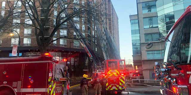A group of firefighters respond to a fire at a high-rise apartment building on Feb. 18, 2023, in Silver Springs, Maryland.