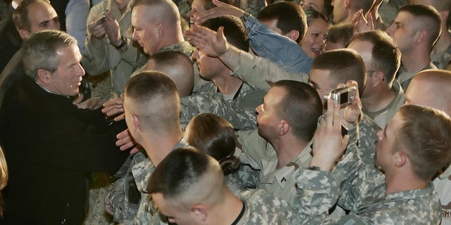 President George W. Bush greets troops during a surprise stopover at Bagram Air Base, Afghanistan, March 1, 2006. Bush made the stop on his way to visit India and Pakistan.
