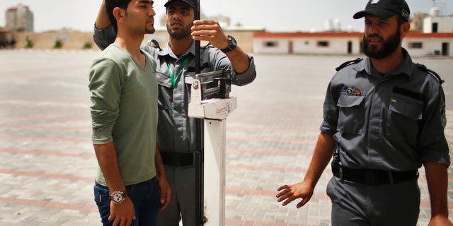 An applicant is measured at a Hamas recruitment center in Gaza City on June 3, 2013. (Reuters/Mohammed Salem)