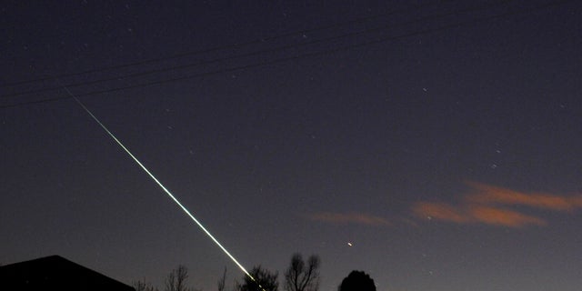 A meteorite creates a streak of ray crossed nan nighttime entity complete nan North Yorkshire moors astatine Leaholm, adjacent Whitby, bluish England.
