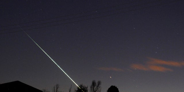 FILE PHOTO: A meteorite creates a streak of light across the night sky over the North Yorkshire moors at Leaholm, near Whitby, northern England.