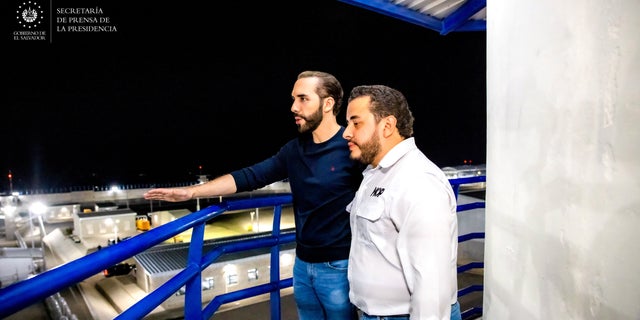 President Nayib Bukele stands on the observation tower with Public Works Minister Romeo Rodriguez during a national television broadcast to unveil the Terrorist Detention Center, February 1, 2023.
