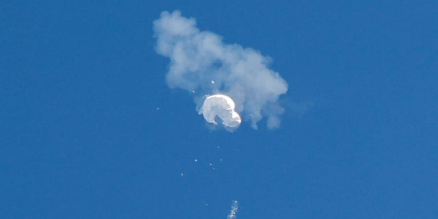 The suspected Chinese spy balloon drifts to the ocean after being shot down off the coast in Surfside Beach, South Carolina, Feb. 4, 2023. (Reuters/Randall Hill)