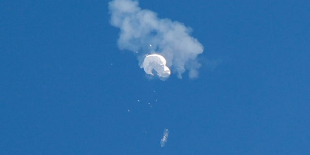 The suspected Chinese spy balloon drifts to the ocean after being shot down off the coast in Surfside Beach, S.C., on Saturday.