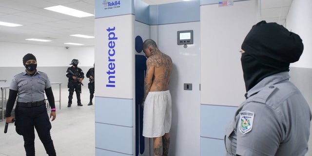 A gang member is being processed upon arrival after 2,000 gang members were transferred to a terrorist detention center, El Salvador President Nayiba Bukele, in Tecoluca, El Salvador, said in this fact sheet distributed by Reuters on Feb.  24, 2023.  