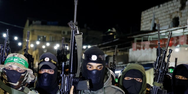 Palestinian gunmen attend a news conference to condemn an Israeli-Palestinian meeting hosted by Jordan in Aqaba.
