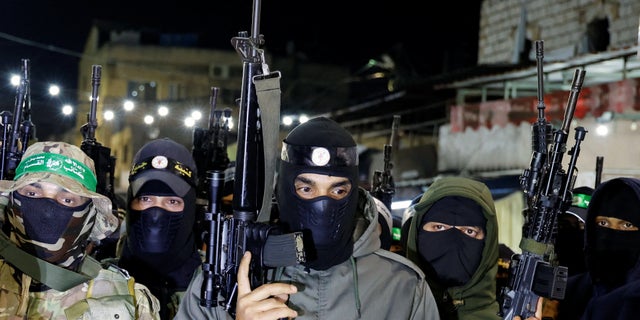 Palestinian gunmen attend a news conference to condemn an Israeli-Palestinian meeting hosted by Jordan in Aqaba.