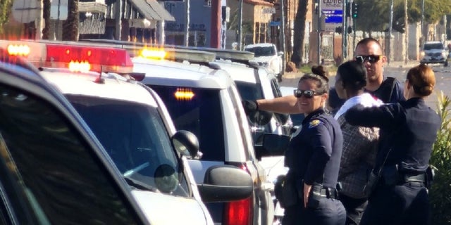 Phoenix police officers at the scene where an officer ingested a substance during a traffic stop.