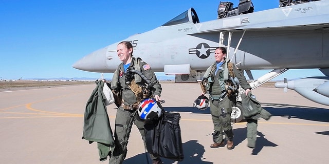 Lt. Lyndsey Evans and Lt. Margaret Dente, both Naval Aviators attached to Electronic Attack Squadron (VAQ) 129, exit an EA-18G Growler after arriving at Luke Air Force Base, Arizona, Feb. 7, 2023.
