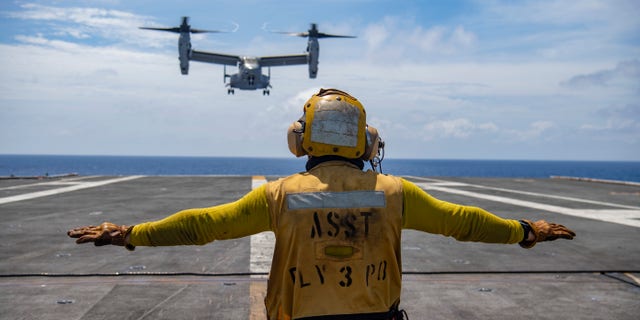 An Osprey prepares to land on the flight deck of the USS Nimitz as it conducts exercises in the South China Sea on Feb. 11.