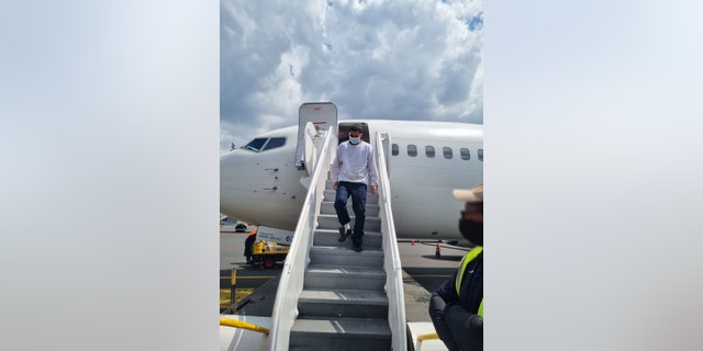 Noe David Alvarez Escamilla, a 24-year-old Salvadoran citizen national wanted for aggravated homicide and illegal associations in El Salvador, disembarks from an ICE Air charter flight Feb. 17 at the Monseñor Óscar Arnulfo Romero International Airport in San Salvador.