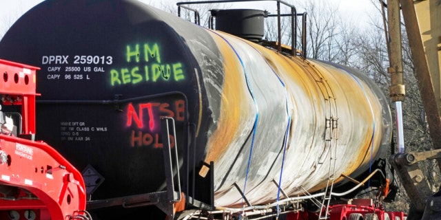 A tank car sits on a trailer as the cleanup of portions of a Norfolk Southern freight train that derailed over a week ago continues in East Palestine, Ohio, Wednesday, Feb. 15, 2023. 