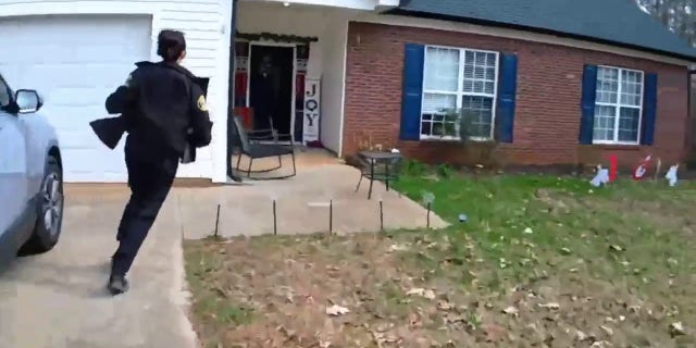 Officer Alexis Callaway runs into a home after a report of an infant that was choking.