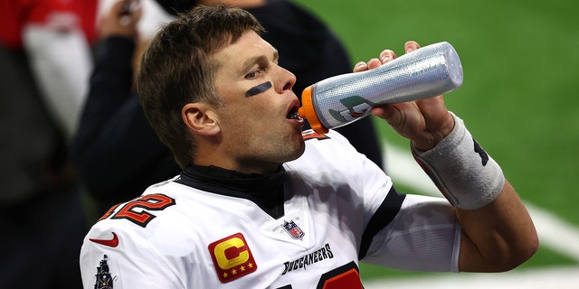 Tampa Bay Buccaneers number 12 Tom Brady drinks water before a game against the Detroit Lions at Ford Field on December 26, 2020 in Detroit.