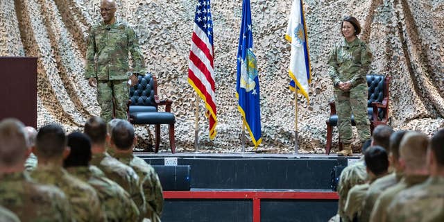 Chief Master Sergeant of the Air Force JoAnne Bass and Air Force Chief of Staff Gen. Charles Q. Brown Jr. speak before the 332nd Air Expeditionary Wing in January 2022. 