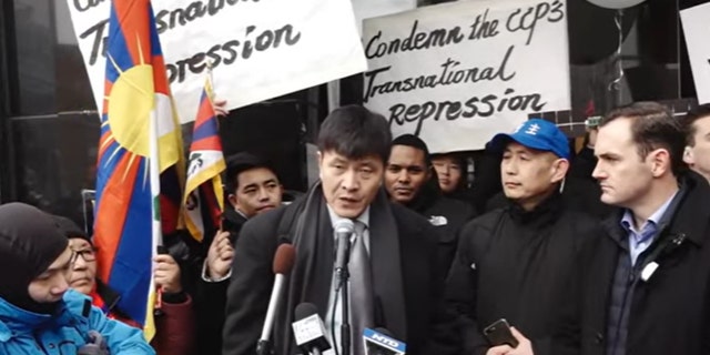 Chinese civil rights activist Zhou Fengsuo speaks at the press event held outside a recently raided Manhattan "police station" of the CCP.