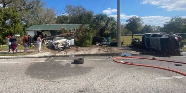 Photos show the massive wreck with damage to the house, a tire and other debris in the road, and a palm tree that fell on top of one of the crashed cars.