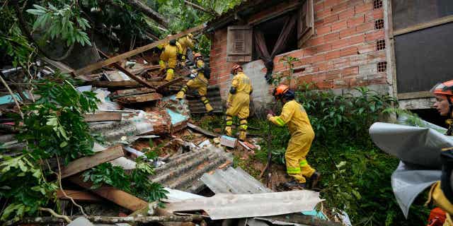 Rescue workers search for survivors after flooding caused landslides near a beach in Sao Sebastiao, Brazil, on Feb. 20, 2023.