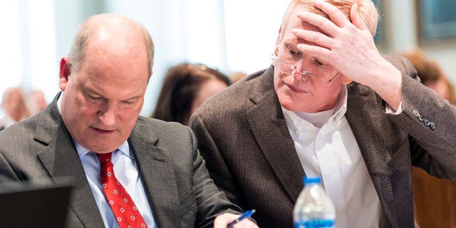 Defense attorney Jim Griffin, left, and Alex Murdaugh look over a document Murdaugh’s double murder trial at the Colleton County Courthouse in Walterboro, SC, on Monday, February 6, 2023.