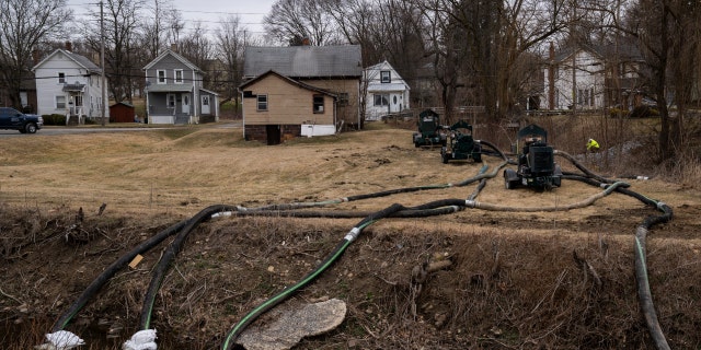 FILE: A clean-up crew works alongside a stream as clean-up efforts continue on February 16, 2023, in East Palestine, Ohio. On February 3rd, a Norfolk Southern Railways train carrying toxic chemicals derailed causing an environmental disaster. 