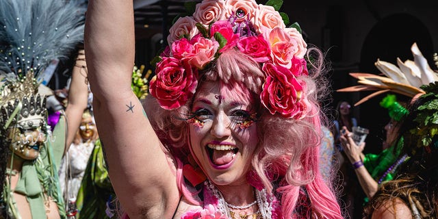 A Mardi Gras attendee wearing a flowered costume waves and smiles after a parade in the French Quarter on Feb. 21, 2023 in New Orleans, Louisiana. Fat Tuesday marks the last day of Carnival season, where costumed attendees flock to multiple parades and parties citywide. 