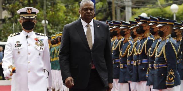 U.S. Defense Secretary Lloyd Austin, center, walks past military guards during his arrival at the Department of National Defense in Camp Aguinaldo military camp in Quezon City, Metro Manila, Philippines, on Thursday.