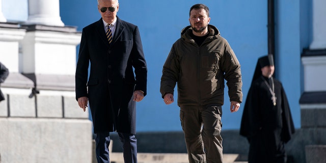 US President Joe Biden (L) walks with Ukrainian President Volodymyr Zelenskyy (R) at St. Michael's Golden-Domed Cathedral during an unannounced visit, in Kyiv on February 20, 2023. 