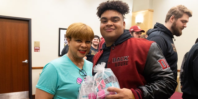 Elon University football player Jon Seaton told Fox News Digital that watching his mother fight breast cancer influenced his drive to give back to others. He's shown here with his mom, Carole Seaton.