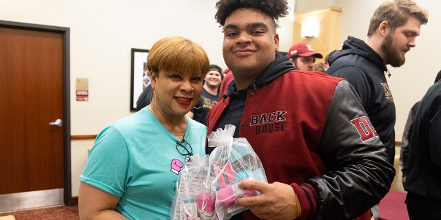 Elon University football player Jon Seaton told Fox News Digital that watching his mother fight breast cancer influenced his drive to give back to others. He's shown here with his mom, Carole Seaton.