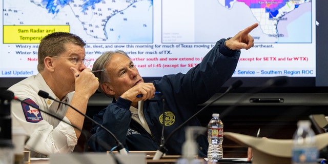 Nim Kidd, chief of the Texas Division of Emergency Management, and Gov. Greg Abbott during a briefing on Jan. 31, 2023, in Austin.